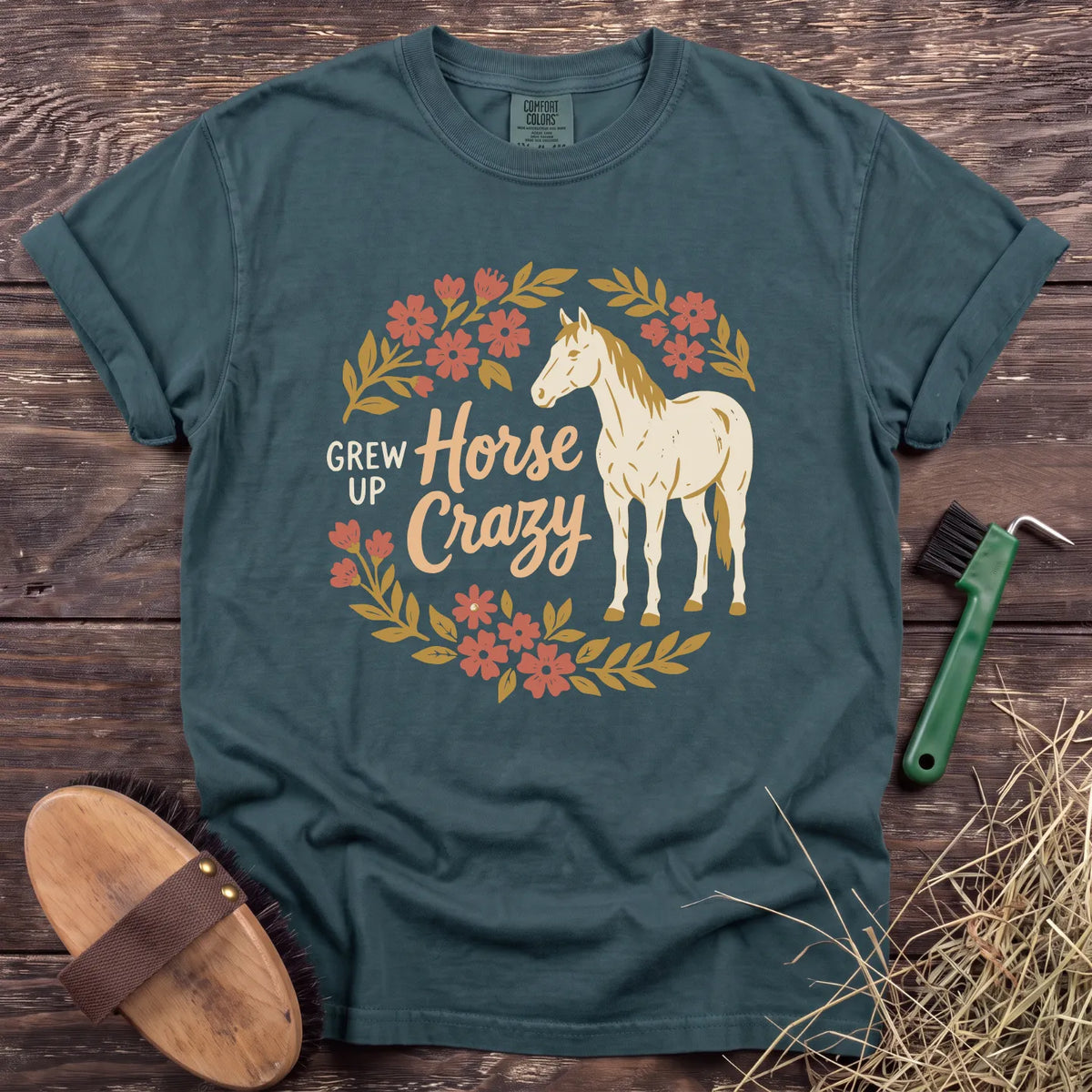 Teal T-shirt featuring "Grew Up Horse Crazy" design with floral accents and a horse graphic. Perfect for horse lovers.