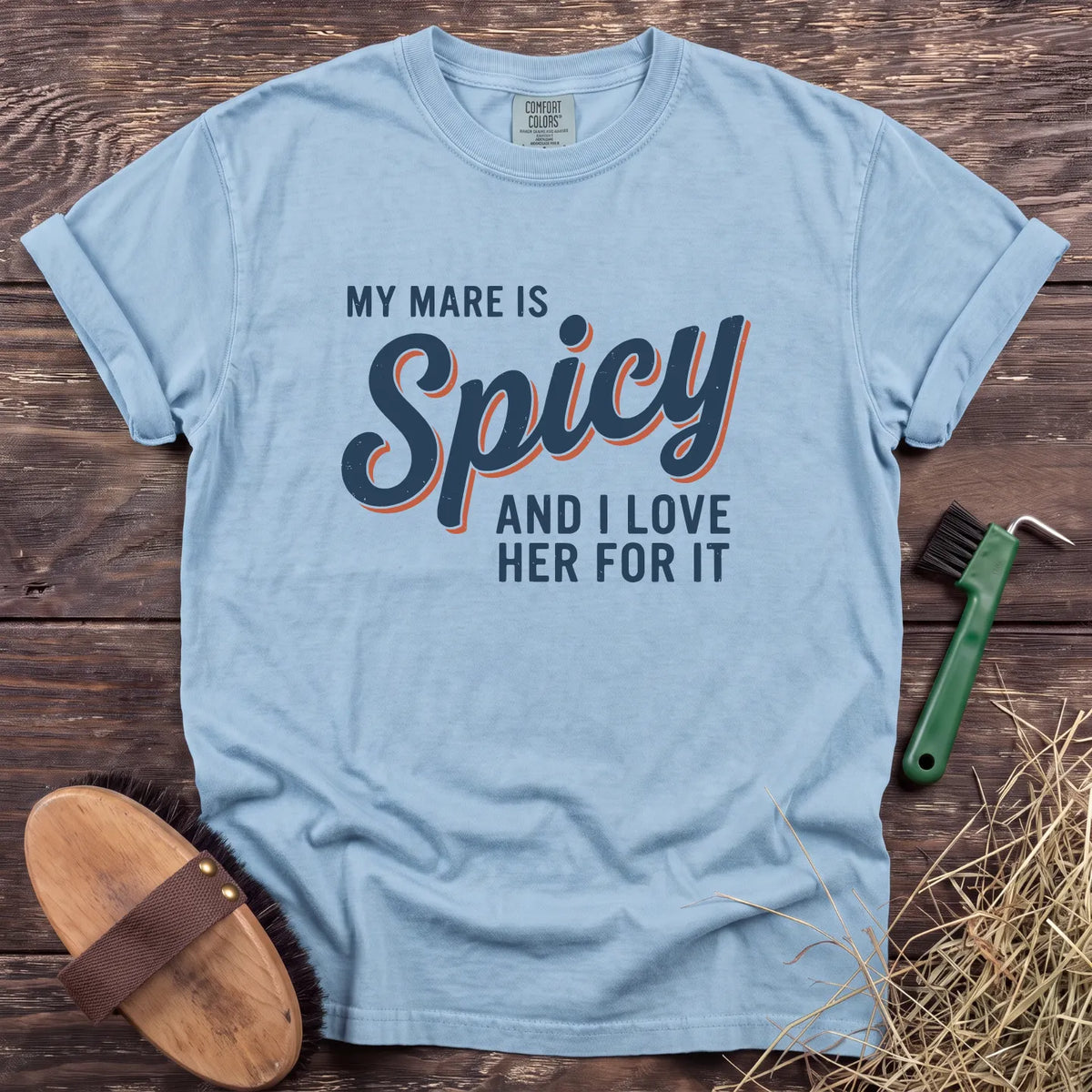 Light blue t-shirt featuring the text "My Mare Is Spicy And I Love Her For It" in bold typography.