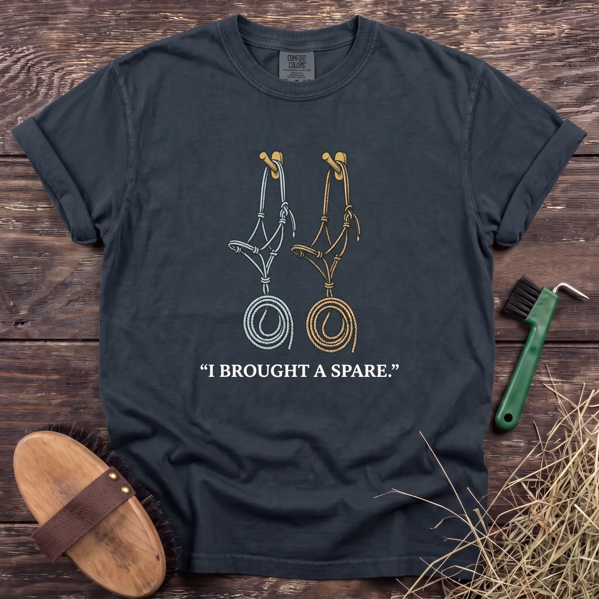 Navy T-shirt featuring two halters and the phrase "I BROUGHT A SPARE" in white text. Perfect for equestrian enthusiasts.