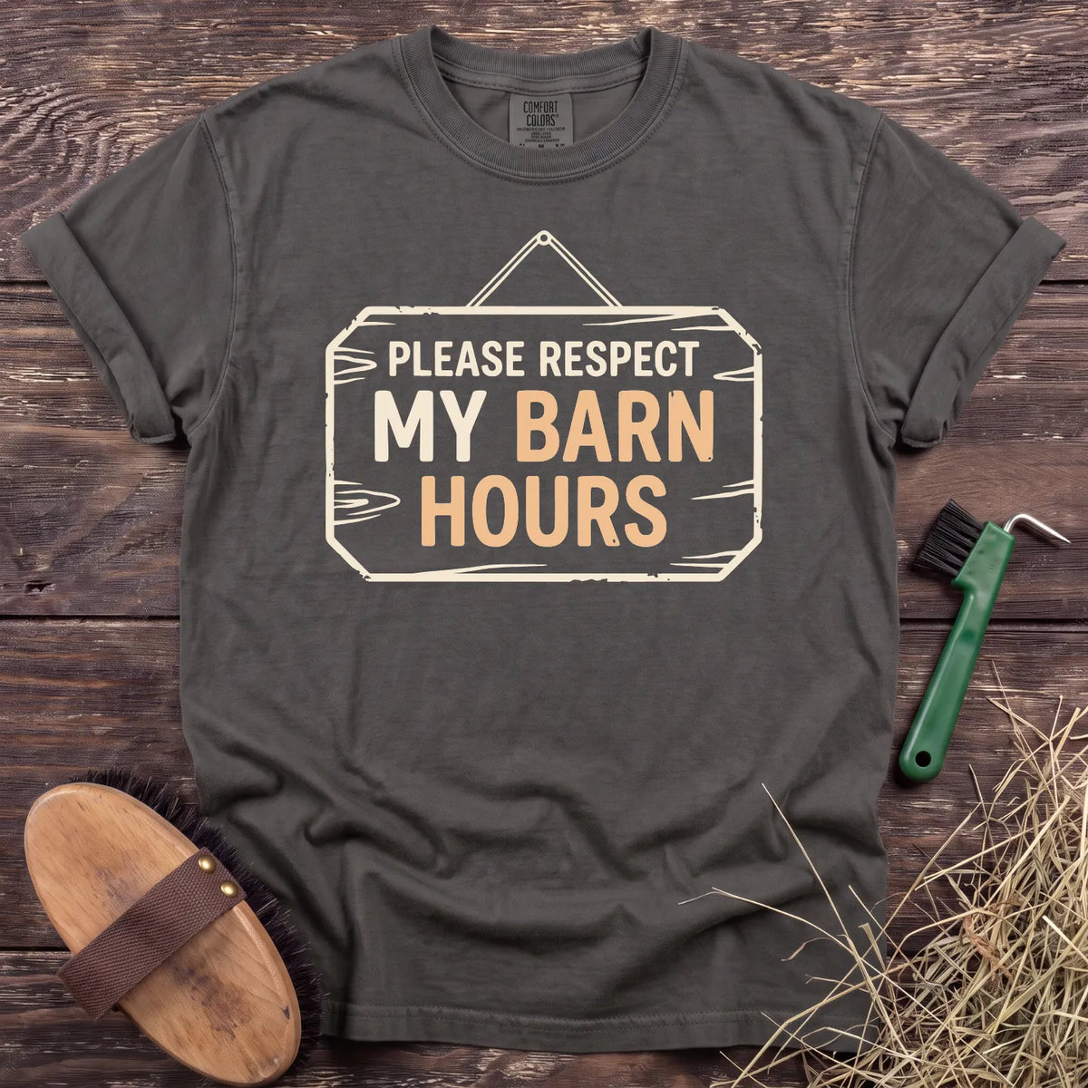 Respect My Barn Hours T-Shirt in Pepper, front view on a wooden barn surface. [color: Pepper]