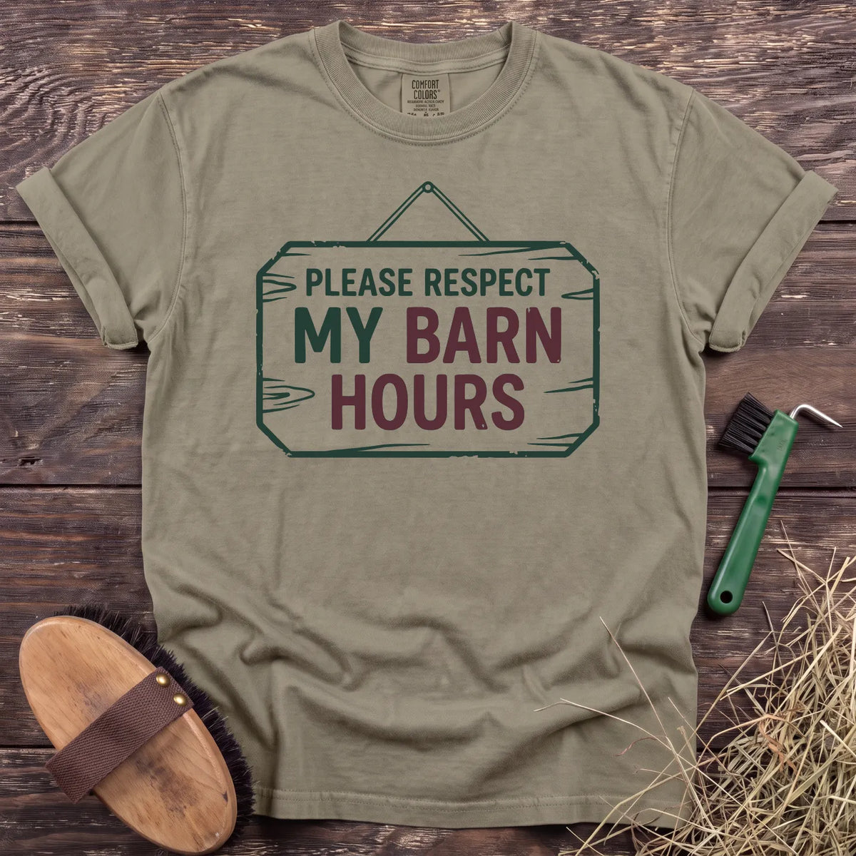 Respect My Barn Hours T-Shirt in Sandstone, front view on a wooden barn surface. [color: Sandstone]